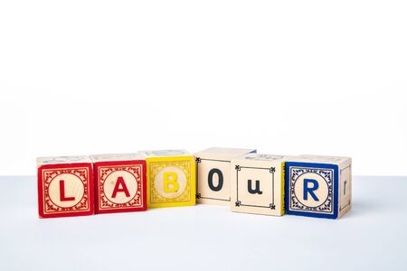 Childrens Wooden Alphabet Blocks Spelling the Word Labourの写真素材