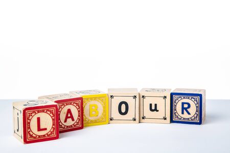 Childrens Wooden Alphabet Blocks Spelling the Word Labourの写真素材