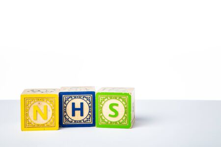 Childrens Wooden Alphabet Blocks Spelling the Word NHSの写真素材