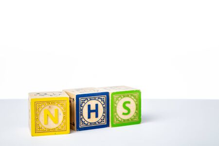 Childrens Wooden Alphabet Blocks Spelling the Word NHSの写真素材