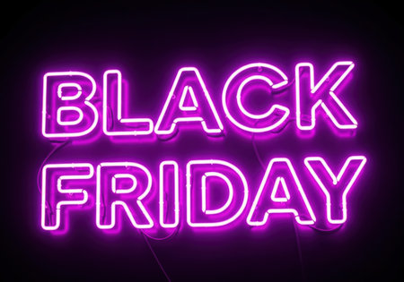 A vivid purple neon sign displays 'BLACK FRIDAY' in bright capital letters, illuminating the darkness. This image captures the essence of the major shopping event.の素材