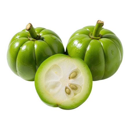 This image showcases three vibrant green garcinias, two whole and one cut in half, isolated on a white background. The cut garcinia reveals its white flesh and seeds.の素材
