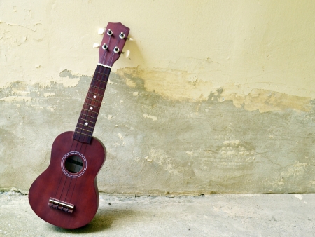 Ukulele on cement backgroundの写真素材