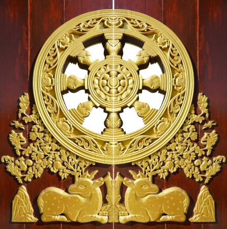 golden deer on door in baromraja temple thailandの写真素材