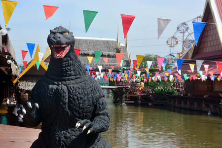 AYUTTAYA,THAILAND - DECEMBER 19, 2014 : A Godzilla model stand outdoor at Thung Bua Chom floating marketのeditorial素材