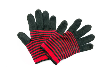 old fabric knitted gloves on white background