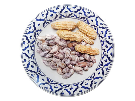 Peanut in ceramic plate on white background
