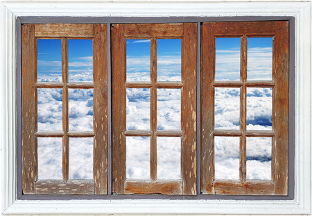 Old wooden window with cloudy sky viewの写真素材