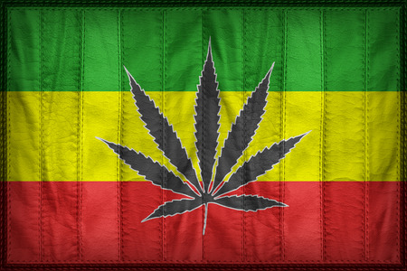 Rasta flag pattern with a marijuana leaf on synthetic leather textureの写真素材