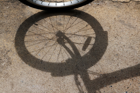 shadow of bike on concrete groundの写真素材