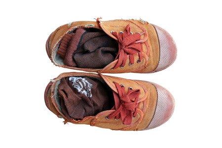 old and dirdy brown canvas students shoes on white backgroundの写真素材