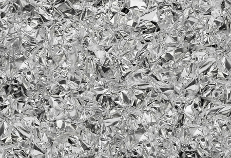 Silver foil  with shiny crumpled surface texture backgroundの写真素材