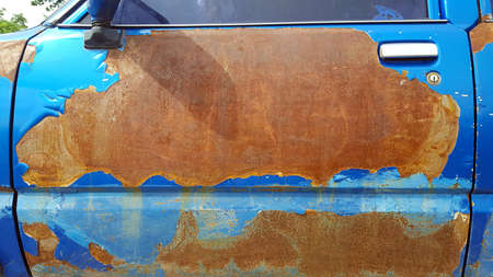cracked color, peeling paint  with dirty rust of old truck