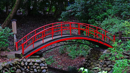 Red bridge in a Japanese gardenの写真素材