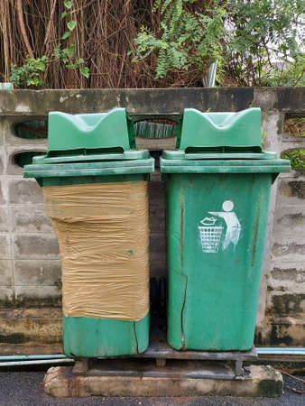 Plastic waste bins are old and damaged.の写真素材