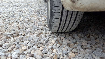 Dusty tires lay on the gravel floor.の写真素材
