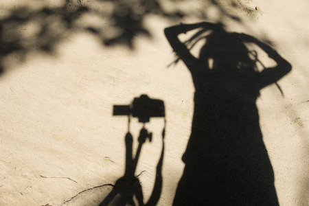 Shadows of people in various  stance on soil background.の写真素材