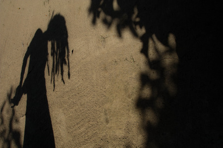 Shadows of people in various  stance on soil background.の写真素材
