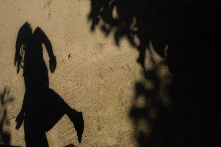 Shadows of people in various  stance on soil background.の写真素材