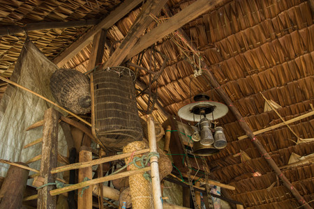 wooden wall  in old Fishing tool and old farm tools and broomの写真素材
