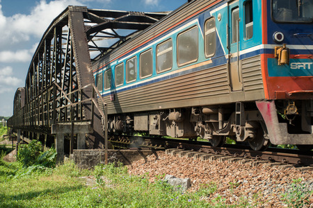 Intercity train passing the countryside of Thailand.