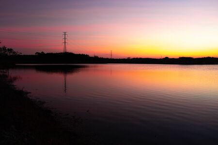 Evening atmosphere on the edge of a large swamp.When the sun goes down.の写真素材