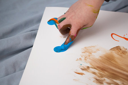 messy finger painting fun toddler hands and fingersの写真素材