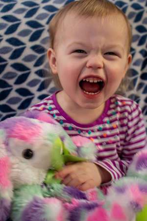 toddler portrait smiling and posing in white and blue backgroundの写真素材