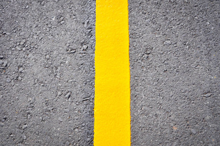 yellow line on asphalt road textureの写真素材