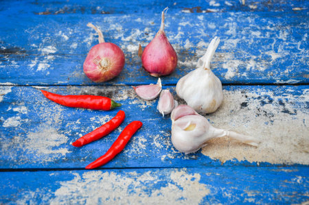 Shallots (red onion), garlics and red chilli set up on woodの写真素材