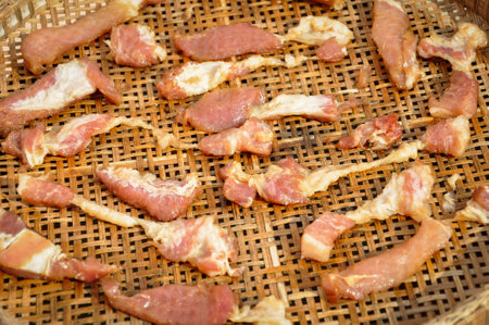 Dried meat on a bamboo tray.