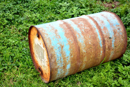 A field and a rusty drum.の写真素材