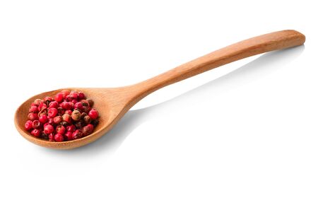 Red peppercorns in wooden spoon on a white background isolated. Natural spice and culinary flavor...