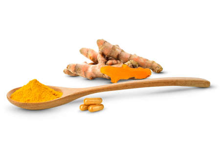 Turmeric in a wooden spoon and turmeric powder and turmeric capsule on white background.の写真素材