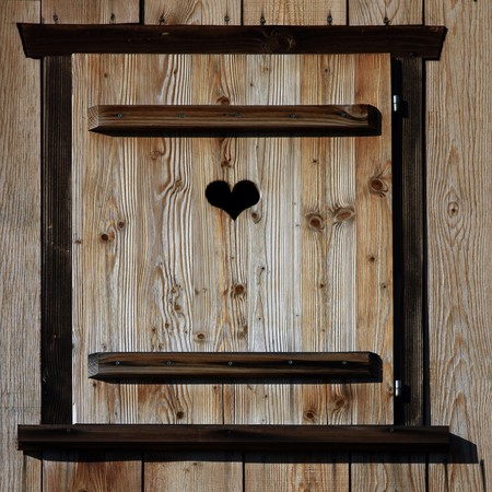 Close view of a wooden shutter with a small heart cut outの写真素材