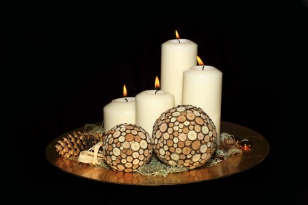 Original advent wreath with four burning candles isolated on a black backgroundの写真素材