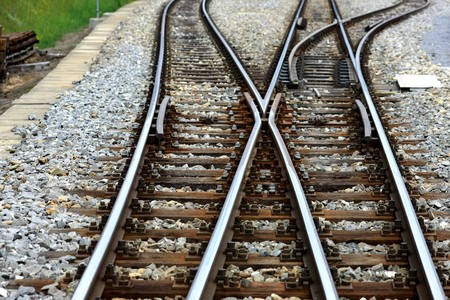 Detail view of a railroad switch with rails ties and gravelの写真素材