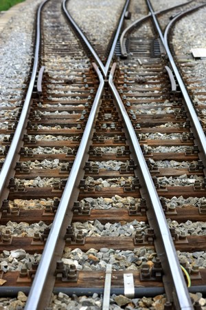 Detail view of a railroad switch with rails ties and gravelの写真素材