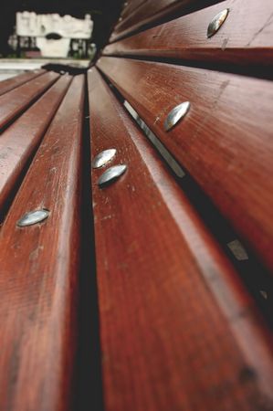 Shot in a park. Wide angle of a bench. A monument in the background.の写真素材