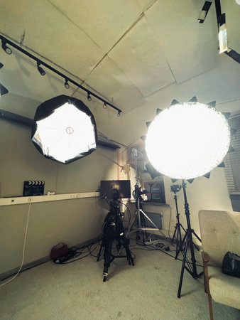 studio lighting setup with softboxes and large strobe lights illuminating empty backdrop. metal standsの写真素材