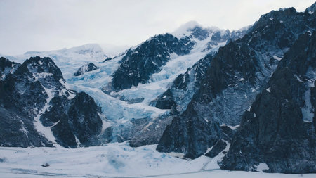 Mountains on snow, white snow mountain peak with clouds in sky, Panorama of Snowy winter in mountain forest.の素材