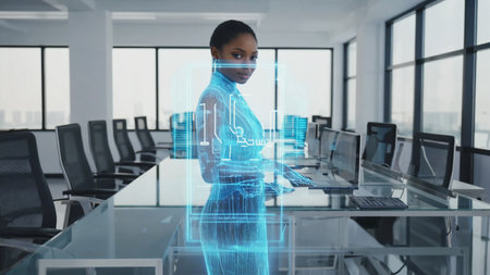 Businesswoman with hologram body interface standing at glass desk in futuristic smart officeの素材