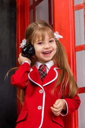 girl with handset laughing and looking at the cameraの写真素材