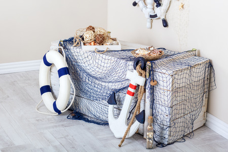 Marine elements of the interior: box, net, anchor and life preserverの写真素材