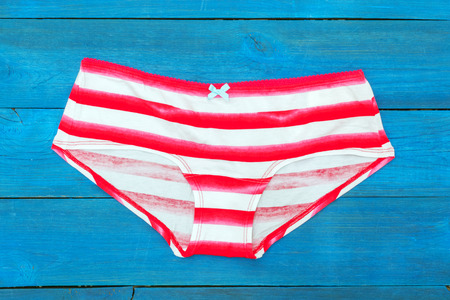 striped panties lying on the aged boardsの写真素材