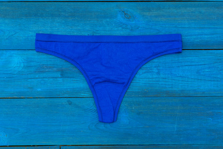 blue panties lying on the aged boardsの写真素材