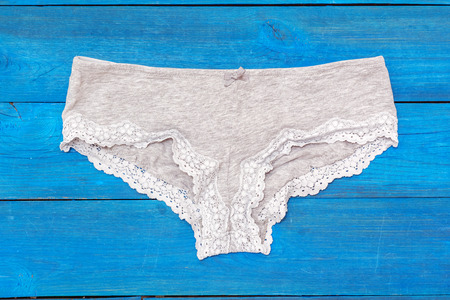 gray panties lying on the aged boardsの写真素材