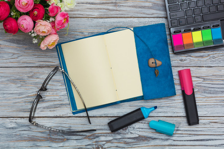 stationery, flowers and notepad on old boards, flat layの写真素材