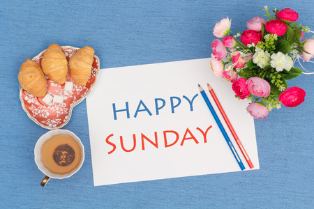 Happy Sunday, croissants with green tea and flowers, view from aboveの写真素材