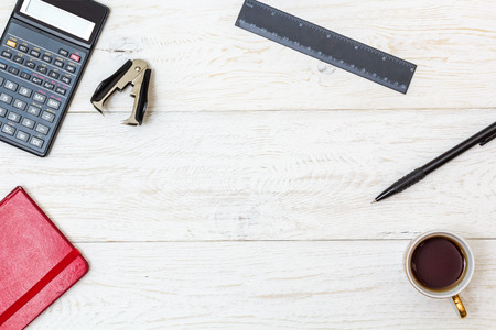cup coffee and stationery on white boards, top view